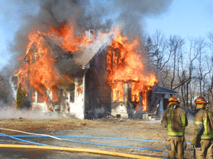 Firefighters bring down house in Chisago business zone